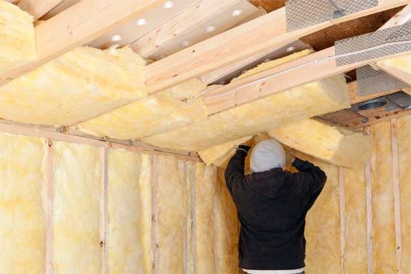 Home Re-Insulation Services — A Man Who Works On Attic Insulation in Appleton, WI